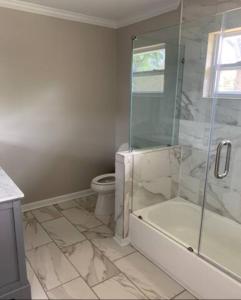 a bathroom with a shower and a tub and a toilet at Atlanta Unit 1 Room 1 - Peaceful Private Master Bedroom Suite with Private Balcony in Atlanta