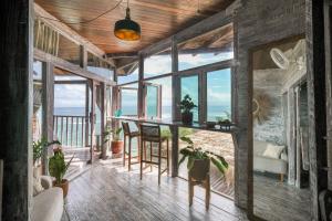 a living room with a table and some plants at Le Cliff Bali in Uluwatu