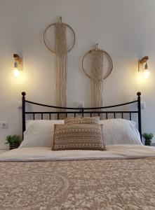 a bedroom with a large bed with a black headboard at Casa di Syrii in Ermoupoli