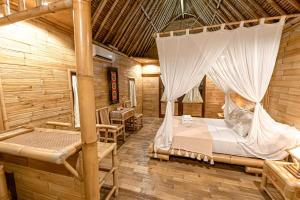 Ein Bett oder Betten in einem Zimmer der Unterkunft Bamboo Bungalows