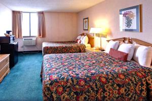ローズビルにあるKey Inn Rosevilleのベッド2台とデスクが備わるホテルルームです。