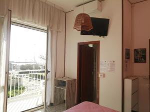 a room with a window and a door to a balcony at B&B GALLETTO in Porto San Giorgio