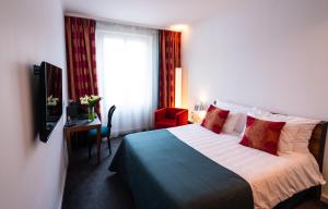 a hotel room with a bed and a window at The Ambassador in Geneva
