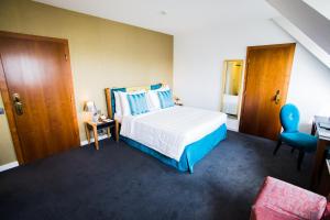 a bedroom with a bed and a desk and a chair at The Ambassador in Geneva