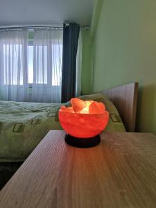 a bowl of oranges sitting on a wooden table at Modern Room With A Great Sunrise - close to the center - in Timişoara