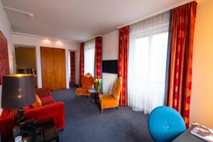 a living room with a couch and chairs and a window at The Ambassador in Geneva