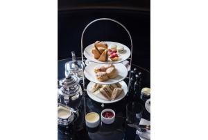 a tray with three plates of food on a table at Old Parsonage Hotel in Oxford