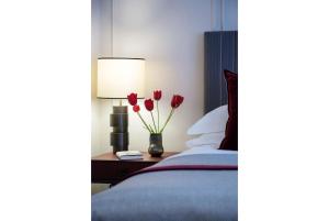 a bedroom with a bed and a table with flowers at Old Parsonage Hotel in Oxford