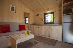 a kitchen with wooden cabinets and a table in a room at Camping belle rivière in Chaniers