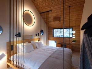 a bedroom with a large bed with a glass wall at vondice hotel in Amsterdam