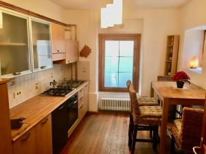 a kitchen with a sink and a table and a window at Centro Storico di Merano in Merano +24 photos