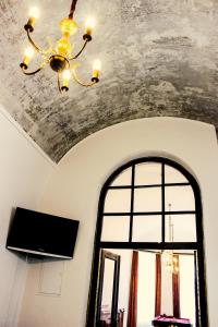 a chandelier and a window in a room at Roth´s Apartment in Košice