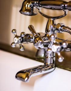 a close up of a bathroom faucet in front of a mirror at Roth´s Apartment in Košice