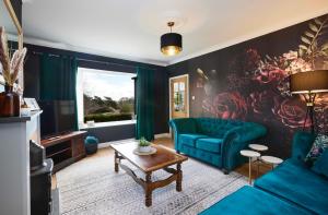 a living room with a blue couch and a tv at Popular with families - Cinder Hill in Whitby