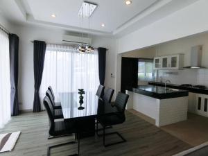 a dining room and kitchen with a table and chairs at Lux9 Private Pool Villa HuaHin in Hua Hin