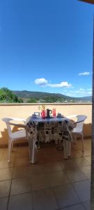 a table with two chairs and a table with a view of the beach at A Cruz de Ferro in Rosal