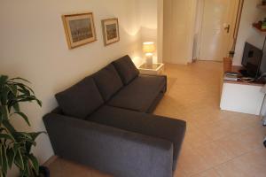 a living room with a couch and a lamp at Apartment Bardolino lake front in Bardolino