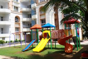 um parque infantil em frente a um edifício de apartamentos em Green Beach Homes em Puri