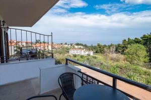 a balcony with chairs and a view of the ocean at Seaview Studios Kriopigi in Kriopigi