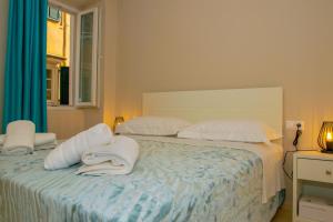 a bedroom with two beds with white pillows and a window at Corfu Old Town Gregory in Corfu Town