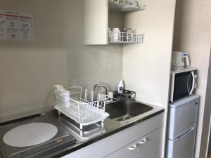 Kuchyň nebo kuchyňský kout v ubytování YANBARU STAY ちゅら宿