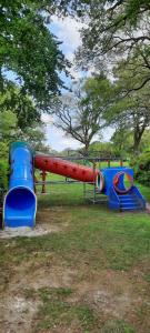 a playground with two slides in a park at Chalet Campingplatz Nordloh in Apen