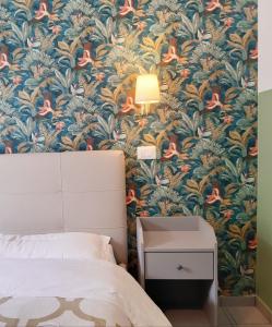 a bedroom with a blue and orange floral wallpaper at Sweet Dreams Roma in Rome