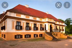 an image of a large house with stairs in front at Haus Sorgenfrei in Caputh