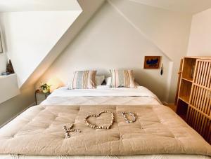 a bed with a heart drawn on it in a bedroom at Romantic Wellness BnB Noordwijk in Noordwijk aan Zee