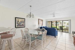 a dining room and living room with a table and chairs at Sea Place 14164, 3 Bedrooms, Sleeps 8, Ground Floor, Pool, Tennis, WiFi in St. Augustine