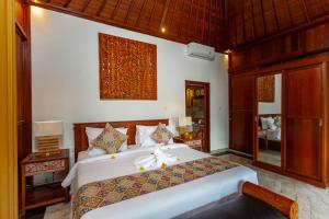 Llit o llits en una habitació de Campuhan Sebatu Resort