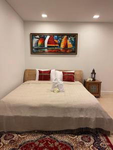 a bedroom with a bed with a painting on the wall at Baan Marakesh Hua Hin in Hua Hin