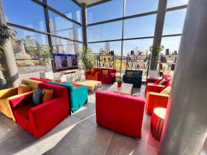 a room with colorful furniture in a building with windows at Campanile Metz Nord - Woippy- Porte du Luxembourg A31 in Woippy