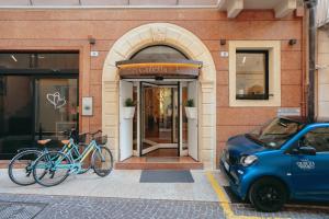 a couple of bikes parked outside of a building at Hotel Giulietta e Romeo ***S in Verona
