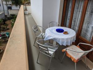 a table and four chairs on a balcony at casetta nel salento in Racale