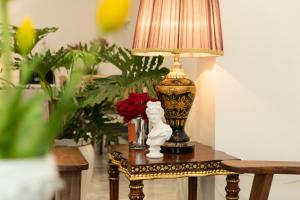a table with a lamp and a statue on it at Ngan Ha 2 Apartments in Ho Chi Minh City