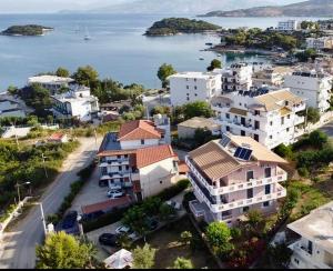 an aerial view of a city with houses and the water at Four Seasons Apartments in Ksamil