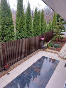a backyard with a fence and a garden with trees at Casa Negoiu in Târgu-Mureş