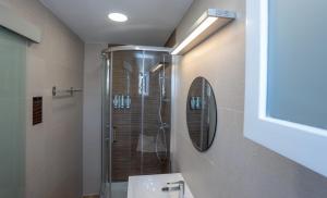 a bathroom with a shower and a sink and a mirror at Hostal Casa Mercedes in Nerja