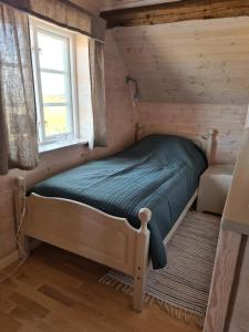 a small bed in a room with a window at Augustas Bed & Breakfast in Falkenberg