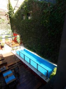 a swimming pool in front of a green wall at Ribera Sur Hotel in Buenos Aires