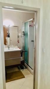 a bathroom with a shower and a sink and a mirror at APPARTEMENT LA GRANDE MOTTE (34280) in La Grande-Motte