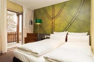 Postel nebo postele na pokoji v ubytování Best Western Hotel Nürnberg am Hauptbahnhof
