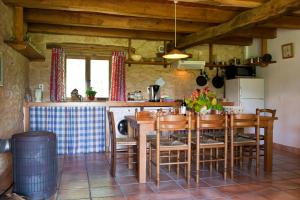 a kitchen and dining room with a table and chairs at Papillon in Sainte-Mondane