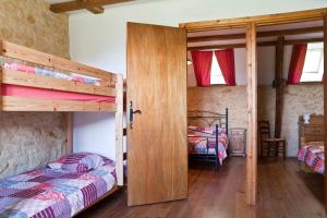 a bedroom with two bunk beds and a doorway at Papillon in Sainte-Mondane