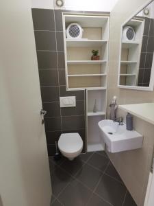 a small bathroom with a toilet and a sink at City Beach Apartment in Split