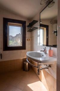 a bathroom with a sink and a window at La casa del Duprè in Siena +59 photos