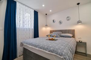 a bedroom with a bed with two glasses on it at Bacvice 21 in Split