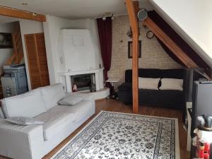 a living room with a white couch and a fireplace at Maisonet Wohnung Badenstedt in Hannover
