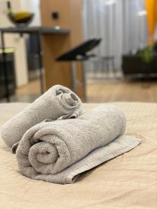 a pile of towels sitting on top of a bed at DV13 Luxury Suite Sofia Center in Sofia